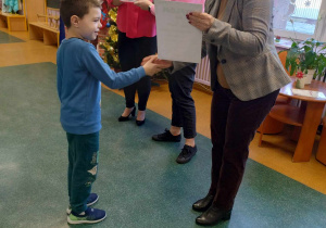 Chłopiec odbiera nagrodę wraz z nagrodą od Pani Dyrektor z zajęcie III miejsca