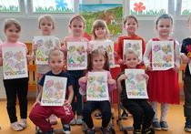 Dzieci z grupy Liski prezentują wykonane przez siebie wiosenne obrazki