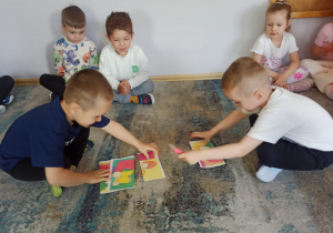 Chłopcy z grupy „Słoneczka” układają puzzle z wizerunkiem taty.