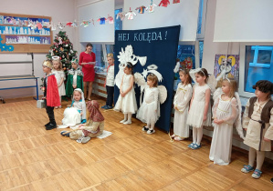 Zdjęcie przedstawia dzieci i jedno z dzieci przebrane za aniołka mówiące swoją kwestię.