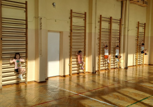 Dzieci podciągają się na drabinkach.