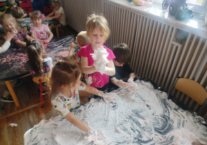 Dziewczynki bawią się masą plastyczną.