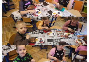 Kolaż zdjęć dzieci z grupy Żabki podczas dekorowania swojej czekolady.