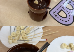 Dzieci zajadają się owocami i piankami maczanymi w roztopionej czekoladzie