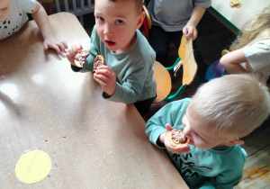 Chłopcy jedzą smakołyki.